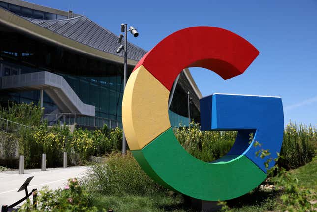 colorful Google logo on display in blue, red, yellow, and green in front of an office building