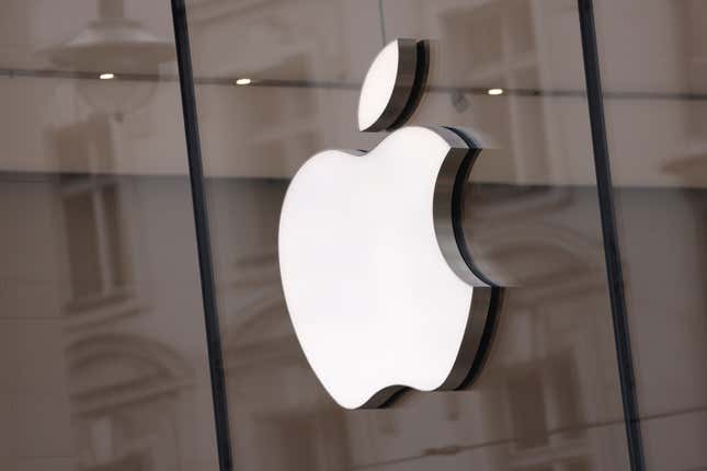 The Apple logo hangs on an Apple Store in Berlin.