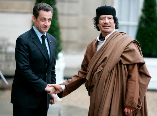 FILE - French President Nicolas Sarkozy, left, greets Libyan leader Col. Moammar Gadhafi upon his arrival at the Elysee Palace, Dec. 10 2007 in Paris. French investigative judges have filed Friday Oct.6, 2023 preliminary charges against former President Nicolas Sarkozy for his alleged involvement in an attempt to mislead magistrates in order to clear him in a case regarding the suspected illegal financing from Libya of his 2007 presidential campaign. (AP Photo/Francois Mori, File)