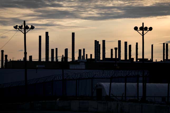 The plant is silhouetted by the early morning light during the ongoing United Auto Workers strike at the Stellantis Toledo Assembly Complex on Thursday, Oct. 26, 2023, in Toledo, Ohio. (Kurt Steiss/The Blade via AP)