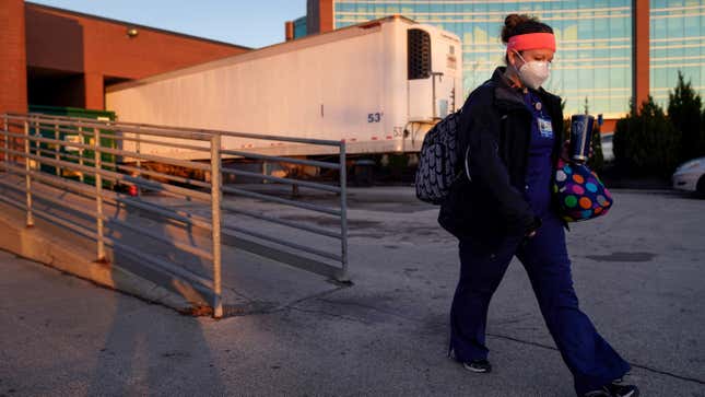 Nurse Jessica Franz walks past a mobile morgue at Olathe Medical Center on Nov. 26, 2020, in Olathe, Kansas.