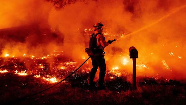 A Butte County firefighter douses flames at the Bear Fire in Oroville, California on September 9, 2020. 