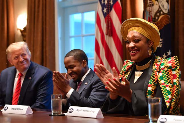 US President Donald Trump (L) sits next to Terrence Williams and Angela Stanton-King (R) during a meeting with African-American leaders in the Cabinet Room of the White House in Washington, DC, on February 27, 2020.