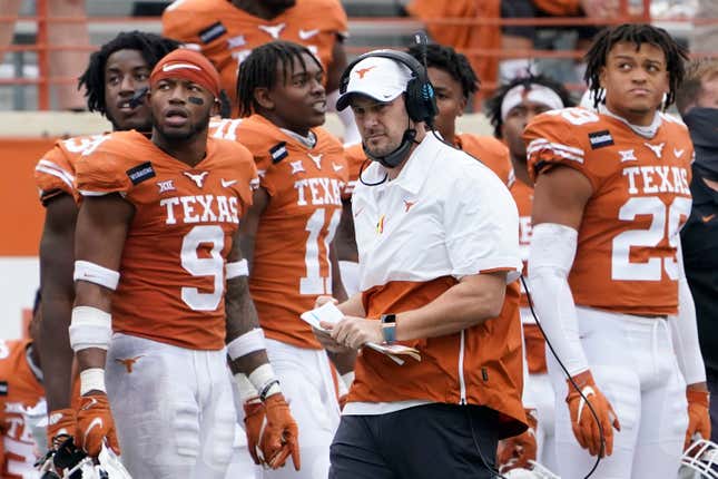 In this Friday, Nov. 27, 2020, file photo, Texas head coach Tom Herman, center, walks on the sideline during the second half of an NCAA college football game against Iowa State in Austin, Texas.