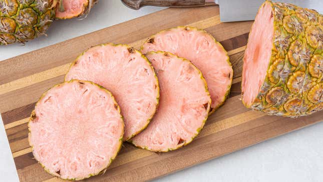 Pinkglow pineapple sliced on a cutting board