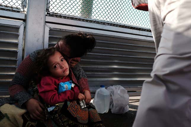 A Honduran child and her mother, fleeing poverty and violence in their home country, waits along the border bridge after being denied entry from Mexico into the U.S. on June 25, 2018 in Brownsville, Texas