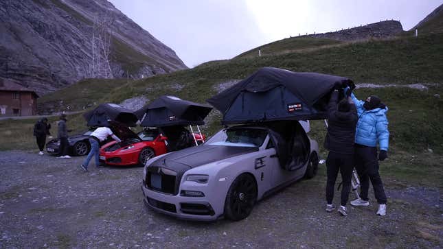 A photo of three supercars with rooftop tents installed. 