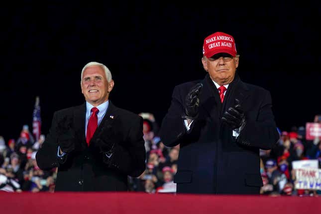 Former Donald Trump arrives for a campaign rally at Gerald R. Ford International Airport, Nov. 2, 2020, in Grand Rapids, Mich., with former Vice President Mike Pence.