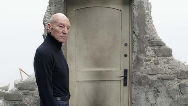 Professor X stands next to a door surrounded by rubble.