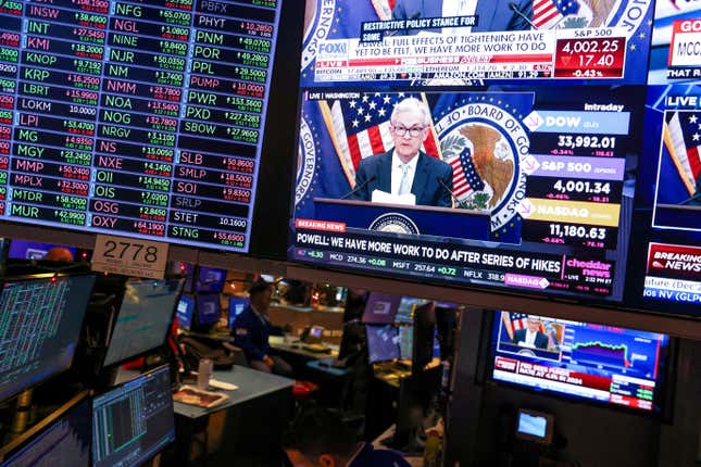 Screens on the trading floor at New York Stock Exchange (NYSE) display the Federal Reserve Chair Jerome Powell, in New York City, U.S., December 14, 2022.