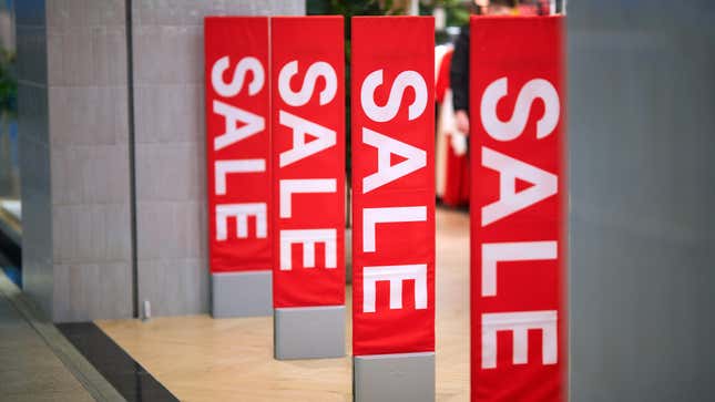 row of "sale" signs in a retail store