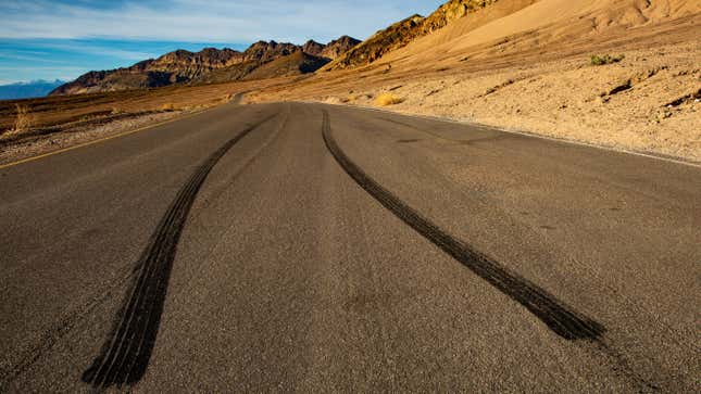 A photo of two tire tracks left on a road in California. 