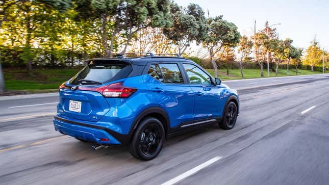 A Blue Kicks driving down a tree-lined road