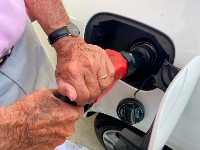 Man filling up tank with Gas at Costco, Kirkland Gas Station, West Palm Beach, Florida. 