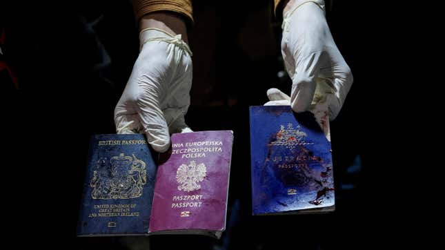 A man displays blood-stained British, Polish, and Australian passports after an Israeli airstrike, in Deir al-Balah, Gaza Strip, Monday, April 1, 2024.