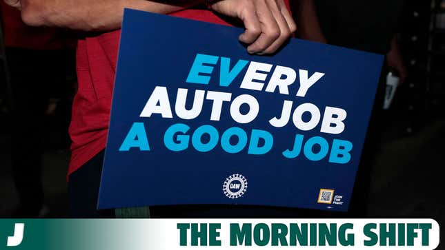 A photo of a UAW member holding a placard that reads "Every Auto Job A Good Job." 