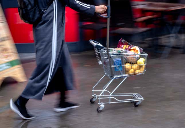 FILE - A woman pushes a small shopping cart outside a discount market in Frankfurt, Germany, on July 27, 2023. Inflation fell again in Europe in August, supporting market speculation that the European Central Bank might pause its record series of interest rate hikes. (AP Photo/Michael Probst, File)