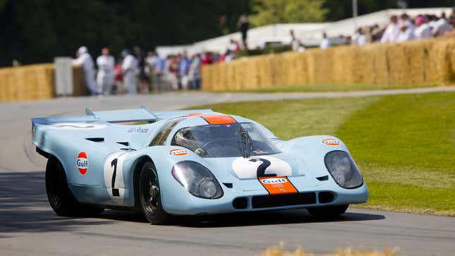 A photo of a blue and orange Porsche 917 race car. 