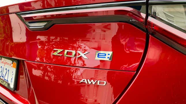 A photo of the ZDX's badges on the trunk of a red car