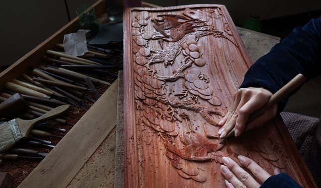 Hand carvings in traditional Chinese rosewood furniture.
