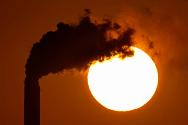 FILE - Emissions rise from the smokestacks at the Jeffrey Energy Center coal power plant as the suns sets Sept. 18, 2021, near Emmett, Kan. The Biden administration is setting tougher standards for deadly soot pollution, saying that reducing fine particle matter from tailpipes, smokestacks and other industrial sources could prevent thousands of premature deaths a year. (AP Photo/Charlie Riedel, File)