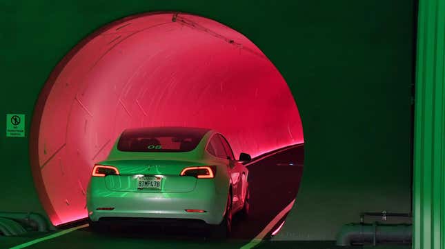 A photo of a Tesla driving into the Boring Company tunnel. 