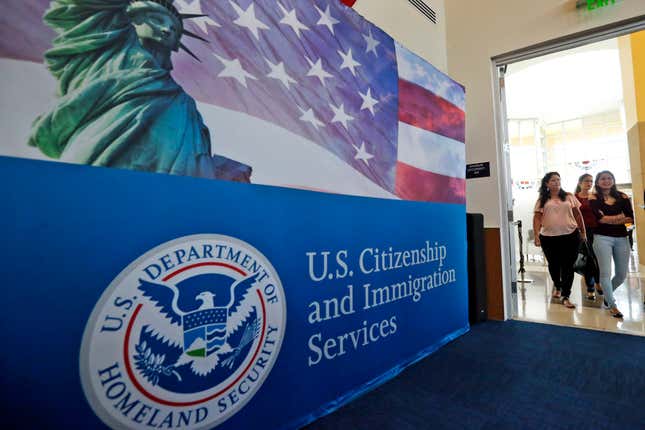 FILE - People arrive before the start of a naturalization ceremony at the U.S. Citizenship and Immigration Services Miami Field Office in Miami, Aug. 17, 2018. Authorities say lottery bids for highly-educated worker visas plunged nearly 40% this year, claiming success against people who were &quot;gaming the system&quot; by submitting multiple, sometimes dubious, applications to unfairly increase their chances. (AP Photo/Wilfredo Lee, File)