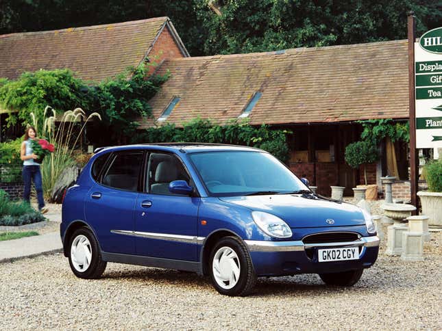 Front-quarter view of a first-generation Daihatsu Sirion in blue parked at a nursery.