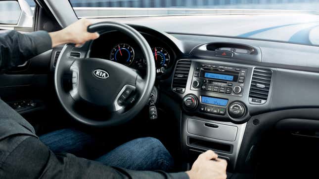 View of the dashboard of a 2007 Kia Optima as it's being driven.