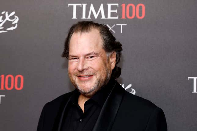 Marc Benioff smiling in front of a backdrop that says TIME 100