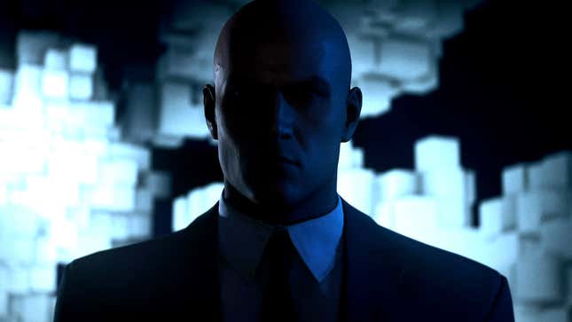 Agent 47 stares at the camera in the dark.