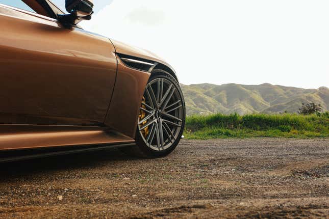 Front wheel of a brown Aston Martin DB12 Volante