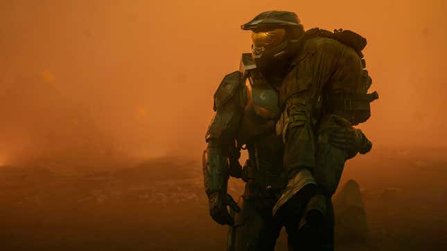 Master Chief carries someone over his shoulder.