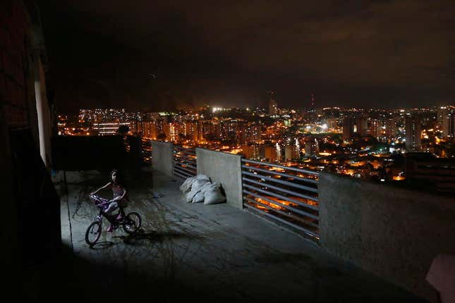 A girl rides her bike in Caracas's vertical slum Torre David