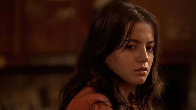 Dina looks at something off-screen.