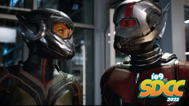 The Wasp and Ant-Man, in their respective armors, stare at each other while standing in a lab.