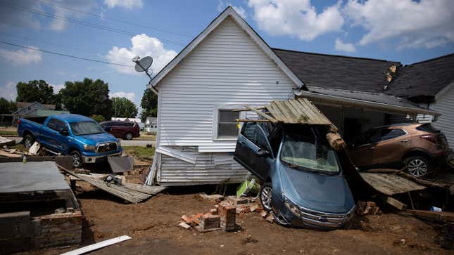 Vehicles are piled up next to a house destroyed by flooding on Aug. 23, 2021 in Waverly, Tennessee.