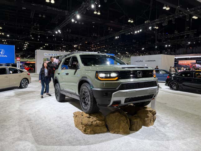 Front 3/4 view of a green Honda Passport