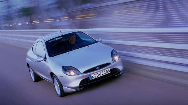 A silver Ford Puma driving on a racing circuit