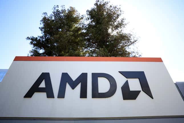 bottom angle of AMD sign with a tree above it