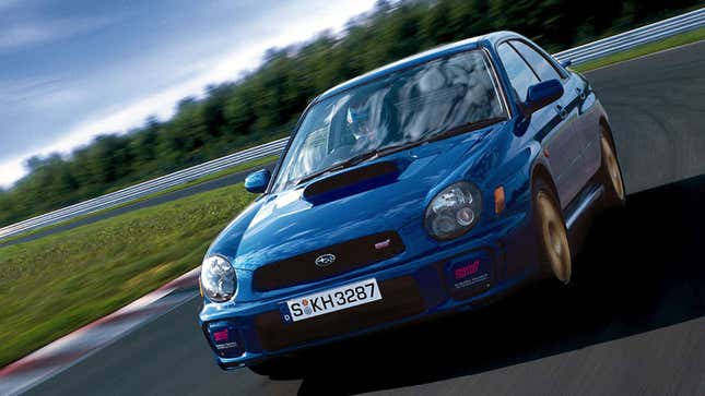 A photo of a blue Subaru WRX on track. 