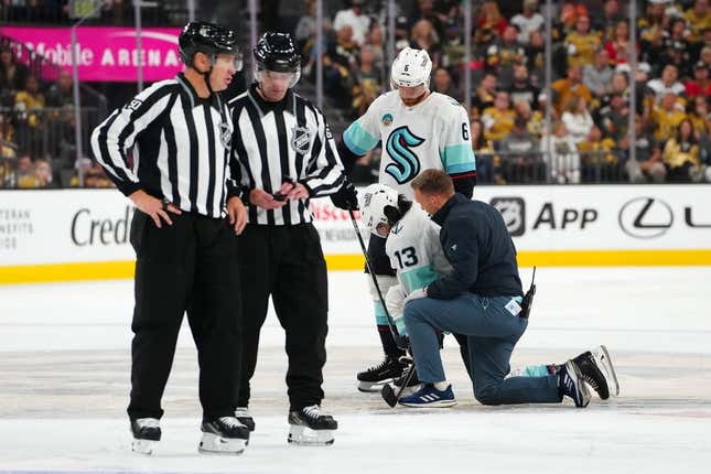 Oct 10, 2023; Las Vegas, Nevada, USA; Seattle Kraken left wing Brandon Tanev (13) is helped to his skates after sustaining an injury from a hit by Vegas Golden Knights center Brett Howden (not pictured) during the third period at T-Mobile Arena.