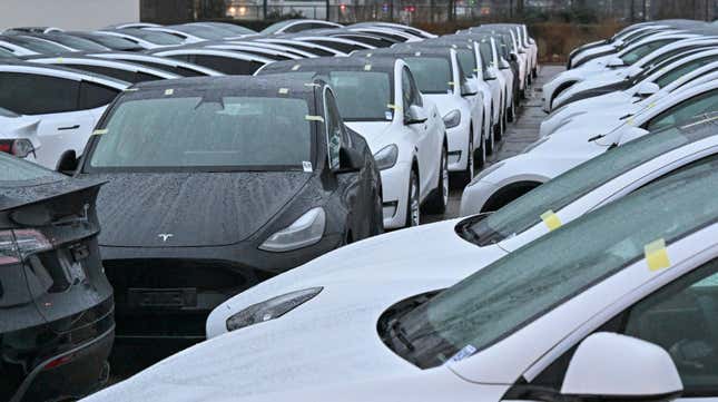 Image for article titled You can see the unsold Teslas piling up in parking lots — from space