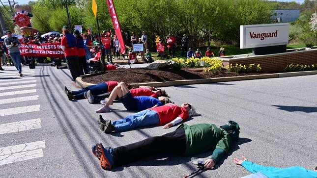 People lay down on the ground during the Vanguard SOS Campaign Fight For Our Future: Rally For Climate, Care, Jobs & Justice on April 22, 2022 in Malvern, Pennsylvania.