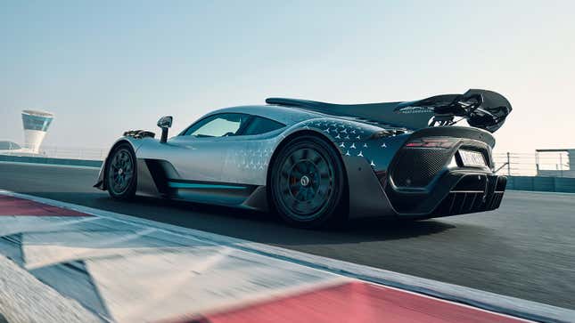 A Mercedes-AMG press image of the One hypercar on a racetrack, viewed from the rear quarter.