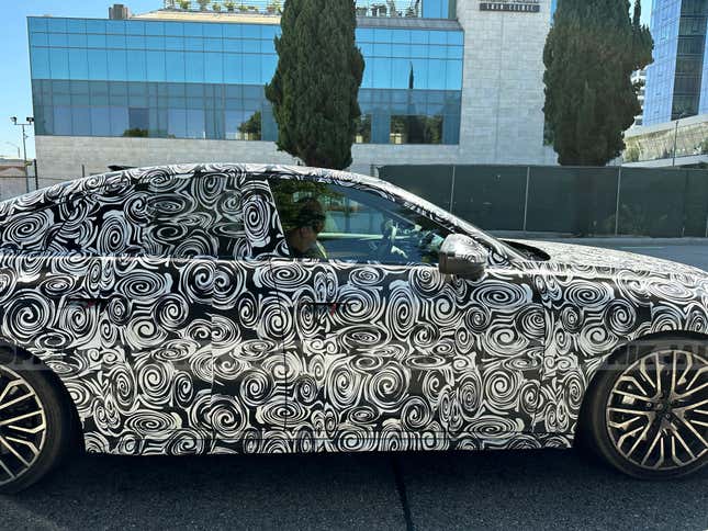 Close-up side view of a camouflaged next-gen Audi S5 Sportback
