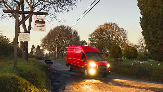 A photo of a red Ford eTransit electric van. 