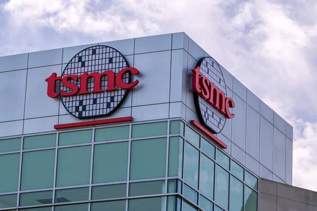 upward view of TSMC logo and signage on two corners of a building