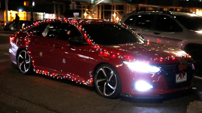 A car festooned with Christmas lights drives through Lower Manhattan on December 08, 2021 in New York City.