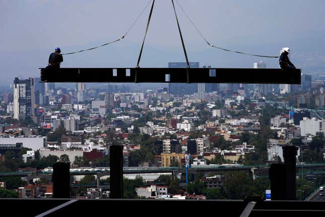 FILE - Construction workers ride on a beam hanging from a crane at the construction site of a residential high rise building in Mexico City, June 17, 2022. Mexico&#39;s economy barely eked out a 0.1% increase in the fourth quarter, bringing estimated growth for 2023 to 3.1%, according to preliminary figures published Tuesday, Jan. 30. 2024, by Mexico’s National Statistics Institute. (AP Photo/Marco Ugarte, File)